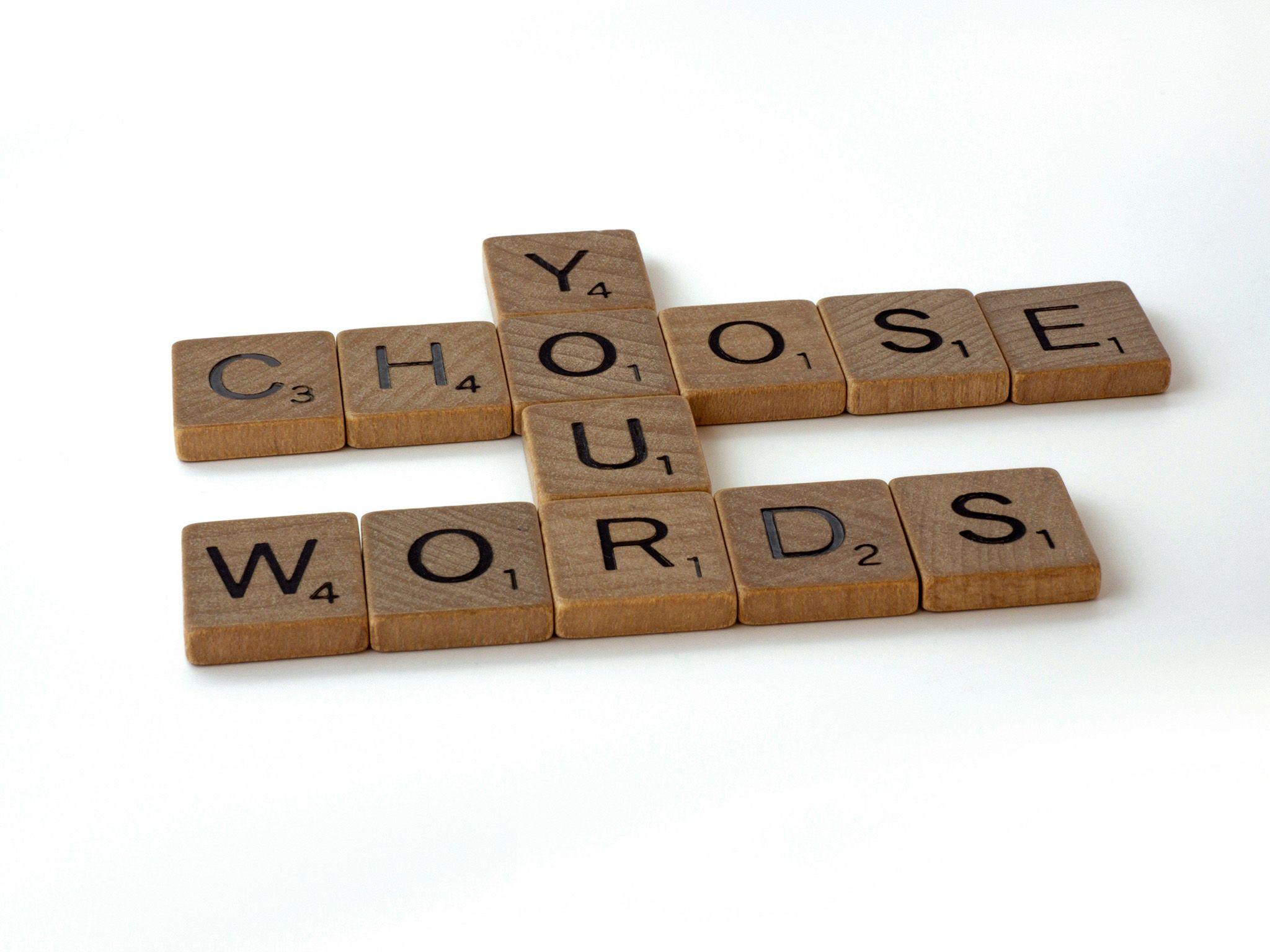 Scrabble tiles spelling "Choose Your Words"